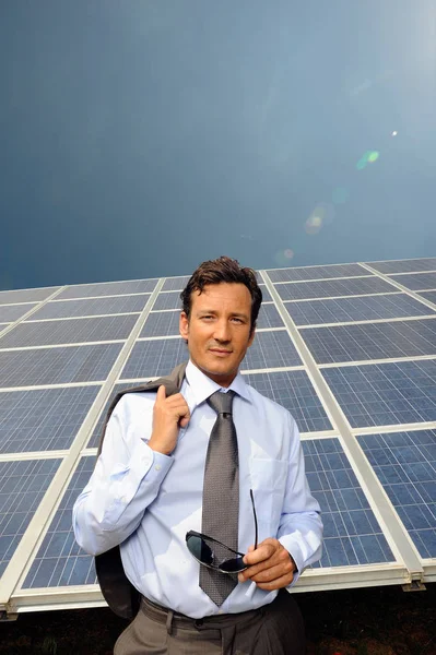 Man standing in front of solar panel