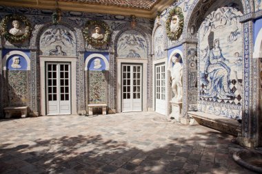 Statues and old azulejos, the iconic blue-glazed ceramic tile work from the area, in the beautiful gardens of the Palacio de Fronteira, in Lisbon, Portugal clipart