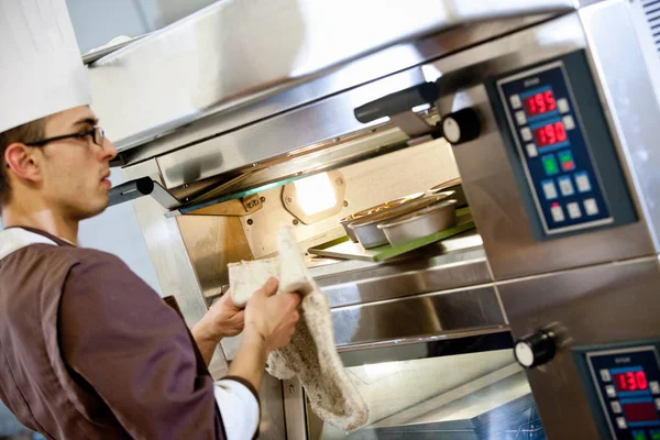 Baker Putting Food Oven Kitchen — Stock Photo, Image