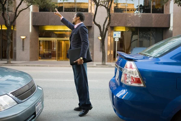 Businessman Signaling Taxi — Stock Photo, Image