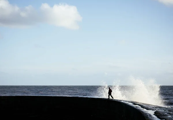 Person Running Away Splashing Wave Cobb Harbour Wall Lyme Regis — Stock Photo, Image