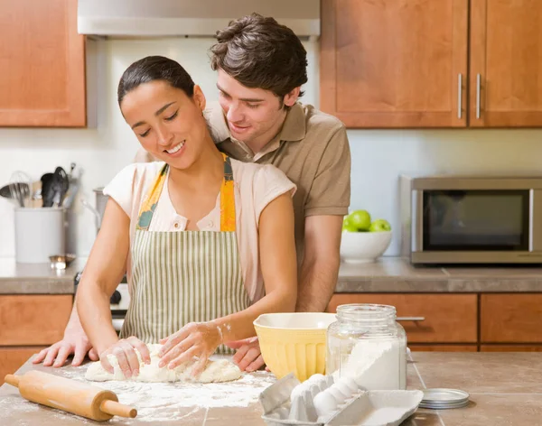 couple baking in kitchen