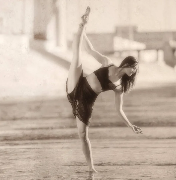 Young woman leg raised, balancing on one leg, b&w, Los Angeles, California, USA