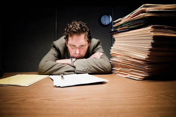 Stressed man with head down on desk