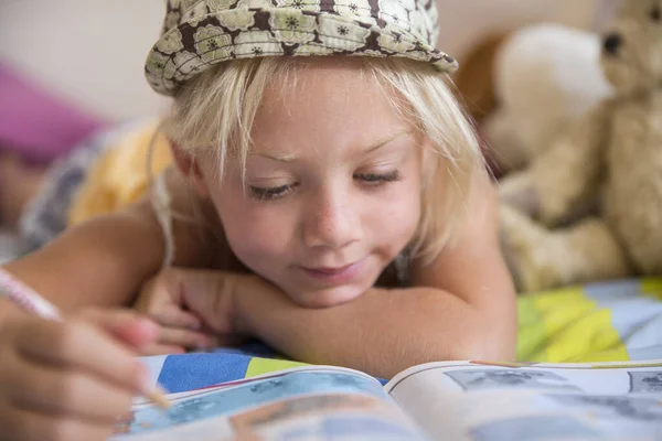 Κορίτσι Που Βρίσκεται Στο Κρεβάτι Κοιτάζοντας Τις Ερωτήσεις Στο Βιβλίο — Φωτογραφία Αρχείου