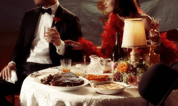 1920s dinner scene with Cote De Boeuf