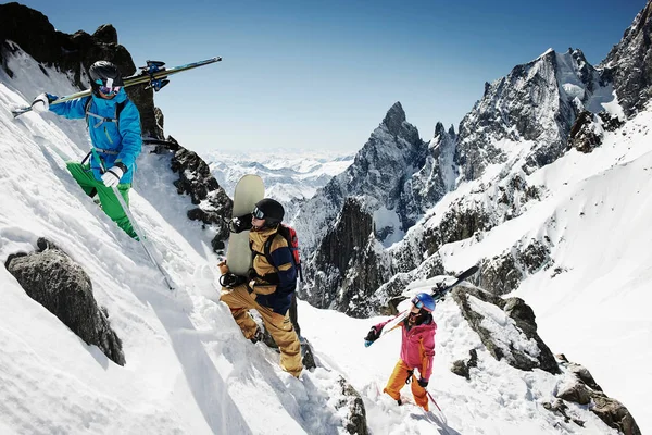 Group of skiers climbing steep mountain