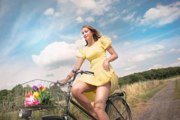 Adolescent girl cycling on dirt track