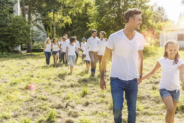 Group of people walking through forest