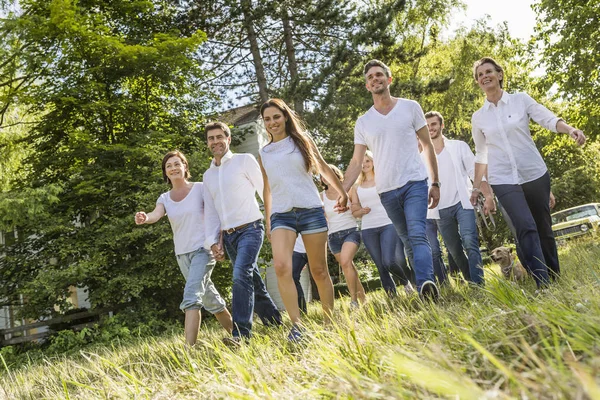 Group of people walking through forest