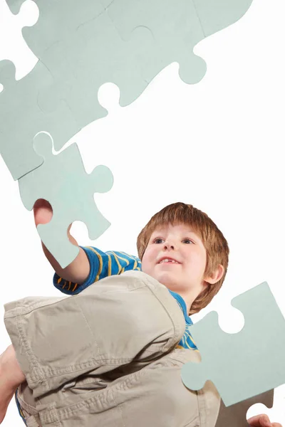 Boy Playing Oversize Jigsaw Puzzle Stock Photo