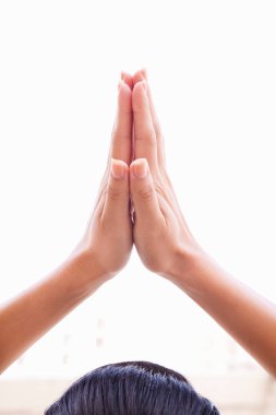 Close up of female hands together in prayer position clipart