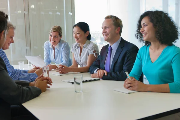 Office workers smiling in meeting in office