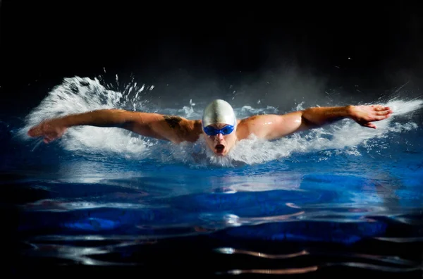 Young man swimming in pool