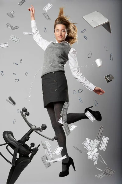 Woman jumping with office items