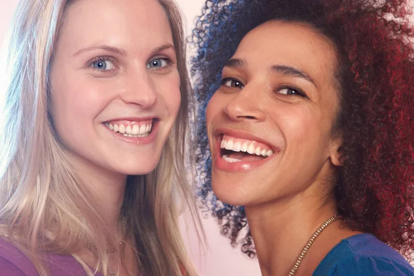 Portrait of two young women laughing