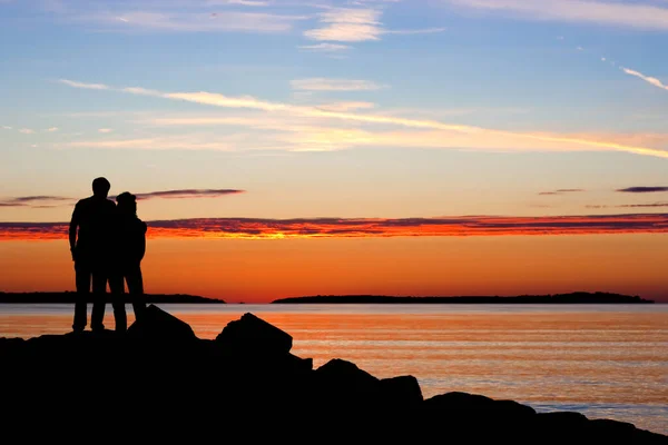与落日一起在海上相拥的夫妻的轮廓 — 图库照片
