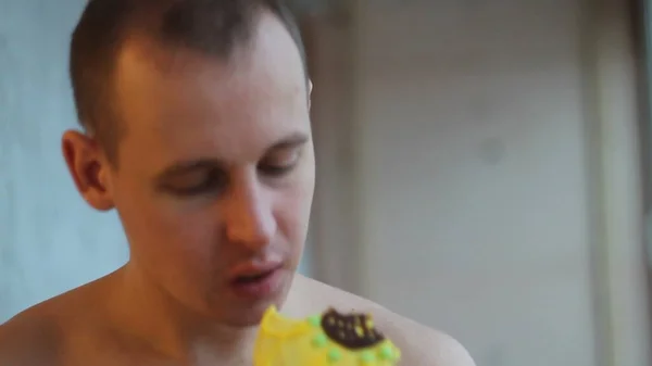 Ein Junger Mann Isst Einen Kuchen Zeitlupe — Stockfoto