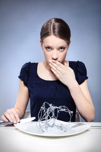 young woman with barbed wire on the plate.