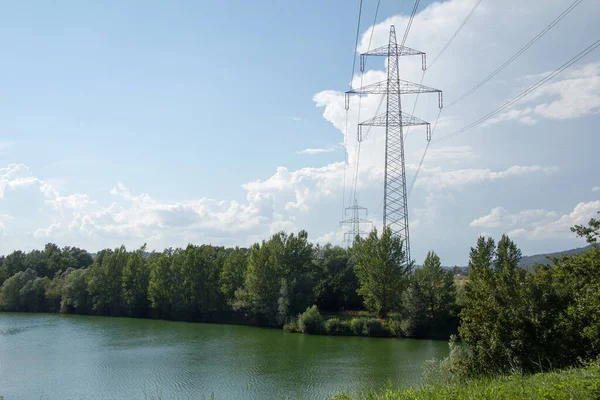 high voltage power lines in the countryside next to natursee in styria