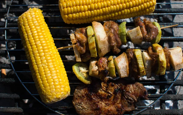 close on meat with fruits and vegetables on the grill,top view