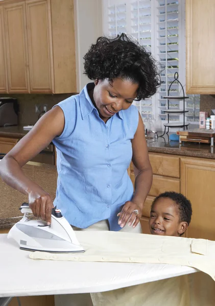 African American Woman Son Ironing Clothes Home — Stockfoto