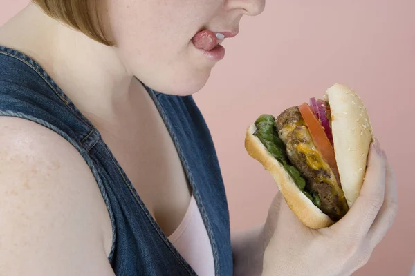 Cropped Afbeelding Van Middelbare Leeftijd Vrouw Met Hamburger Gekleurde Achtergrond — Stockfoto