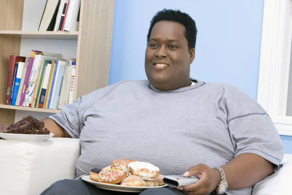 African American Obese Man Watching Television Plate Donut — Stock Photo, Image
