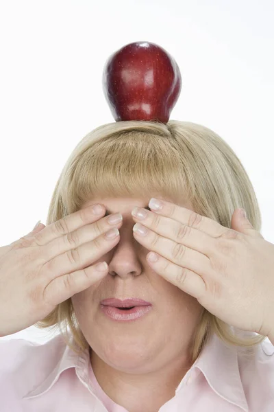 Mature Woman Balancing Apple While Covering Eyes Isolated White Background — Stock Photo, Image