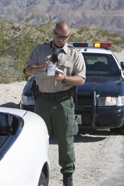Mature Traffic Officer Uniform Writing Ticket Stock Picture