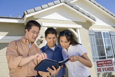Real estate agent with couple buying new house clipart
