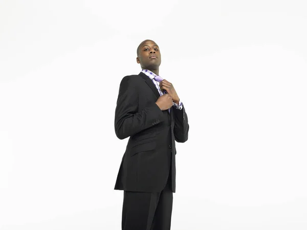 Portrait Confident Businessman Adjusting Tie White Background — Stock Photo, Image