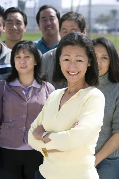 Portrait Happy Woman Standing Hands Folded People Background — Φωτογραφία Αρχείου