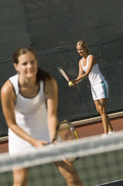 stock image Female player getting ready for a shot with partner standing in foreground