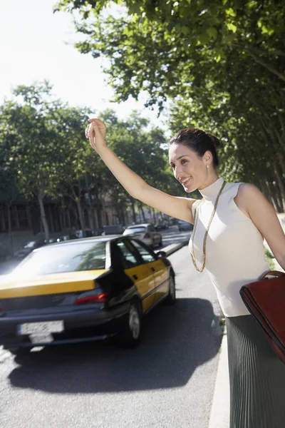 Happy Businesswoman Hailing Cab While Standing Corner Road Royalty Free Stock Photos