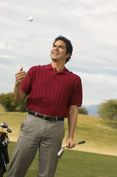 Happy Mature Man Holding Golf Club While Tossing Ball — Stock Photo, Image