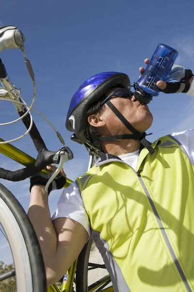 Senior Male Cyclist Drinking Water Stock Photo