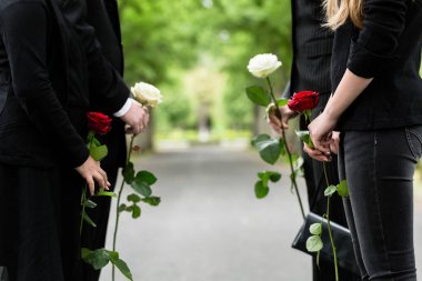 Family in guard of honor at funeral, only torso of people to be seen clipart