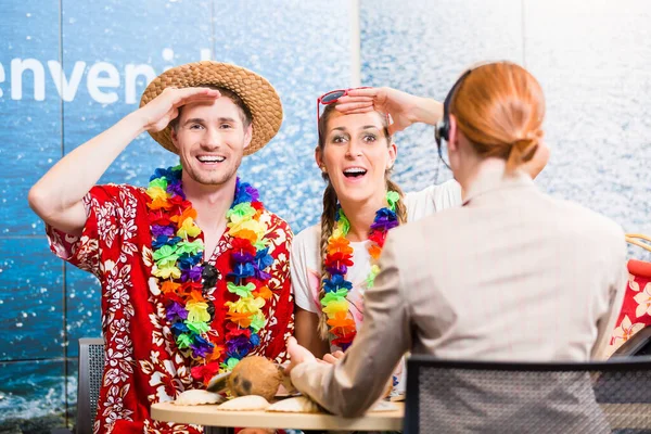 Tourists in travel agency anticipating vacation having good service rendered by operator