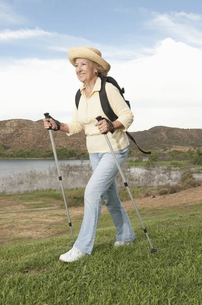 Eine Glückliche Seniorin Die Mit Wanderstöcken Unterwegs Ist — Stockfoto