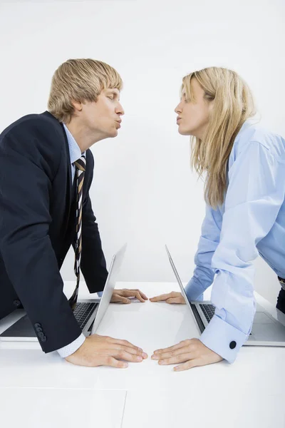 侧面图的业务情侣接吻在办公室 — 图库照片