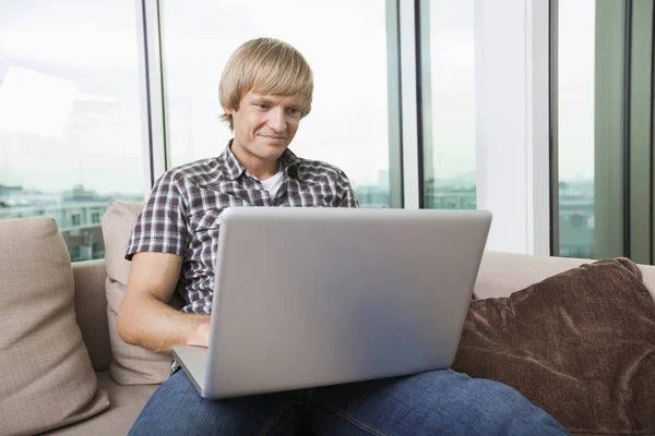 Smiling Mid Adult Man Using Laptop Sofa Home — Stock Photo, Image
