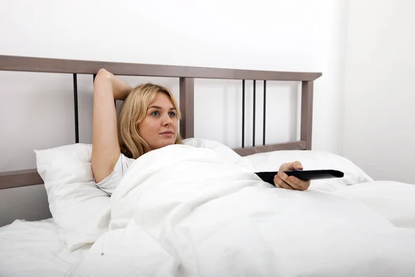 Young Woman Changing Channels Remote Control Bed — Stock Photo, Image