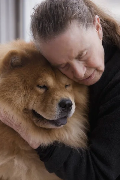 Chilean woman hugging dog