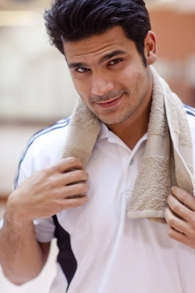 Hispanic man smiling in gym