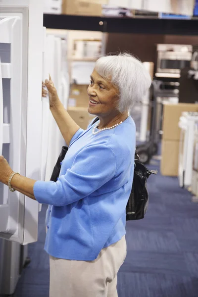 Senior African American woman shopping for appliances