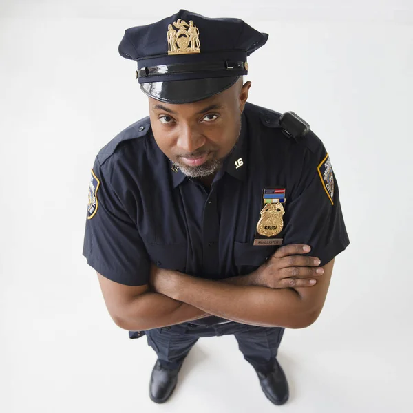 African American policeman with arms crossed