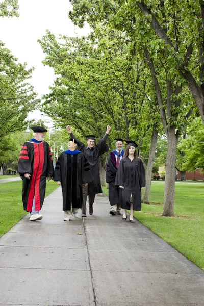 Professors and students walking to graduation