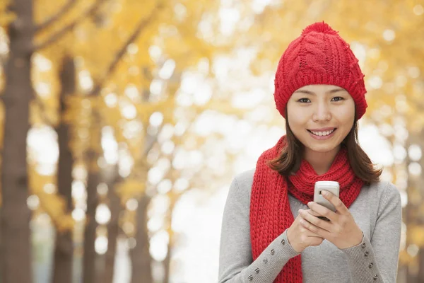 Chinese woman text messaging on cell phone