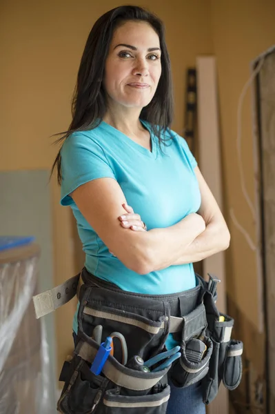 Hispanic contractor wearing tool belt